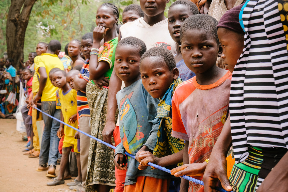 Children and families line up outside a distribution centre in South Sudan. With your help we can ensure they receive another month’s food. 