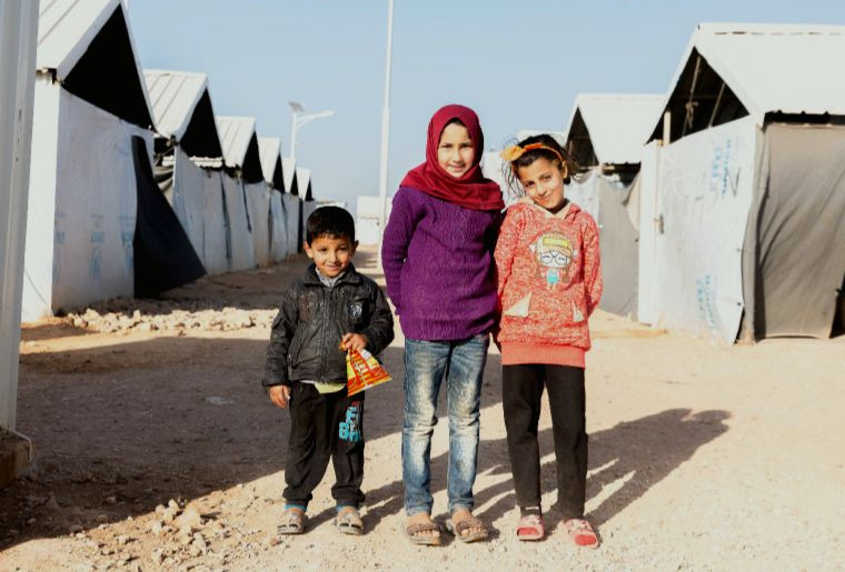 Three children in a World Vision refugee camp in Jordan